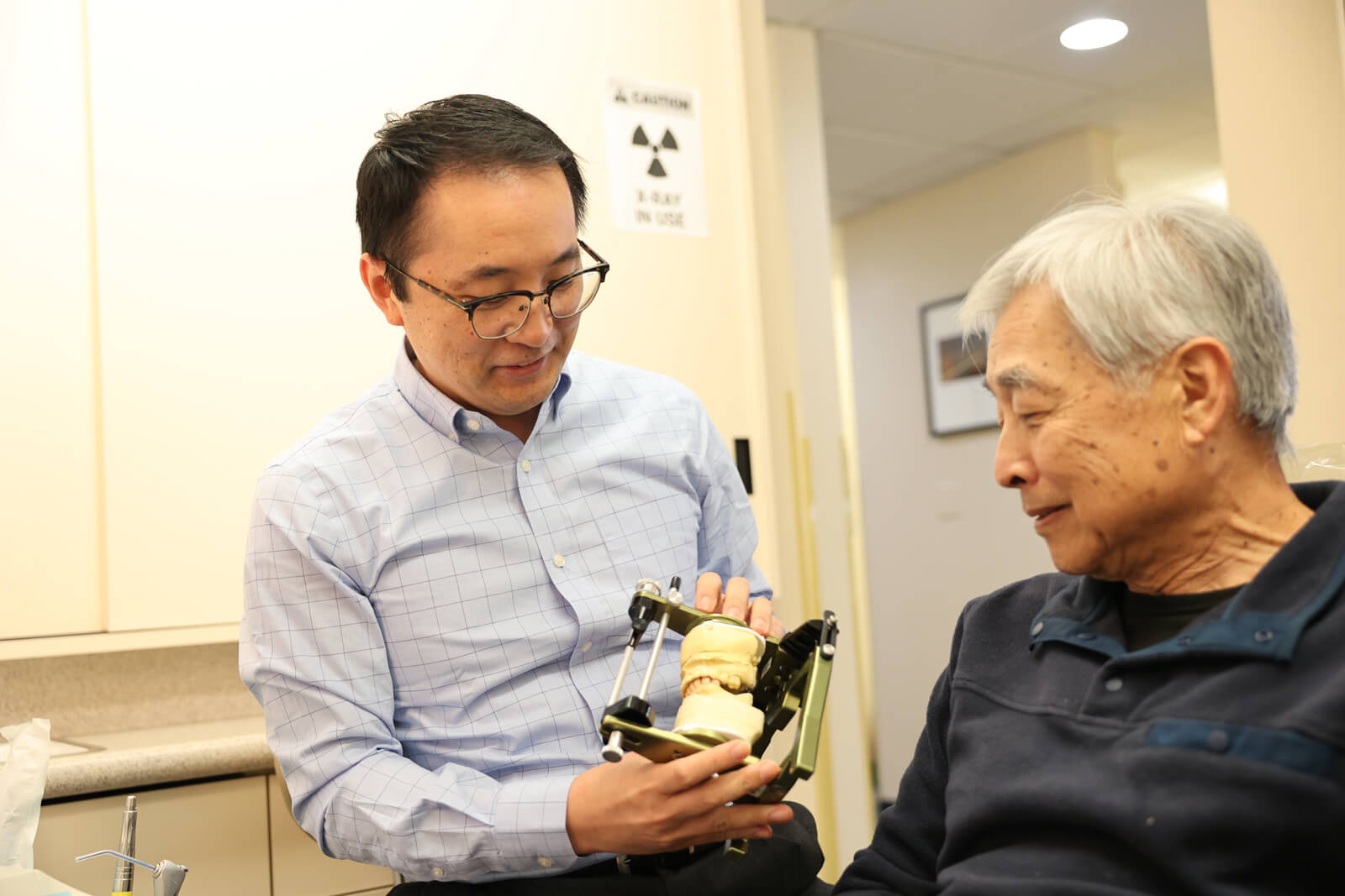 Dr Frank Showing Denture to him